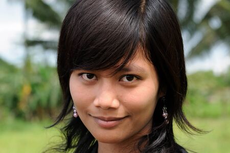 YOGYAKARTA, JAWA, INDONESIA - MARCH 23: Young Indonesian girl inhabiting the capital island Jawa in Indonesia, Yogyakarta on March 23, 2011のeditorial素材