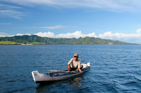KOMODO, FLORES, INDONESIA - APRIL 17: Islander the Komodo in Indonesia is fishing from the small boat, Komodo on April 17, 2011のeditorial素材