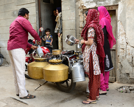 JUNAGADH, GUJARAT, INDIA - JANUARY 17: Door-to-door seller of the milk in the Gujarat state in India, Junagadh in January 17, 2015のeditorial素材