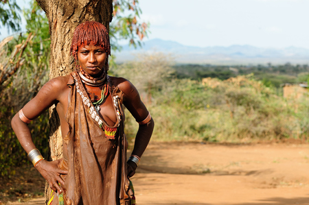 TURMI, OMO VALLEY, ETHIOPIA - JULY 29: Portrait of the woman from Hamer people resting under the tree in transit to the local marketplace in Turmi, Omo valley in July 29, 2013のeditorial素材