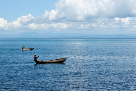 MATEMA, TANZANIA - APRIL 29: Natives from above the lake Malawi swimming in the traditional canoe made of the one-piece tree mango in Tanzania, Matema in April 29, 2013のeditorial素材