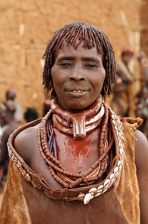 TURMI, OMO VALLEY, ETHIOPIA - JULY 29: Portrait of the woman from Hamer people resting under the tree in transit to the local marketplace in Turmi, Omo valley in July 29, 2013のeditorial素材