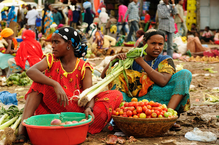 HARAR, ETHIOPIA - SEPTEMBER 12: The Ethiopian woman is selling vegetables on the marketplace in the Harar town in Ethiopia, Harar in September 12, 2013のeditorial素材