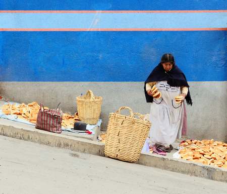 LA PAZ, BOLIVIA - OCTOBER 27: Ethnic woman selling the bread in steep streets to the Bolivian capital city in the La Paz in South America in October 27, 2011のeditorial素材