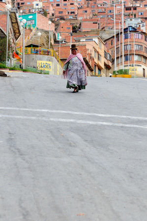LA PAZ, BOLIVIA - OCTOBER 27: The woman in the ethnic dress is going along steep streets of the capital city of Bolivia of the city La Paz in South America in October 27, 2011のeditorial素材