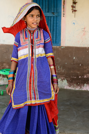 BHUJ, INDIA - JANUARY 13: The young girl in the ethnic dress from the Gujarat state is going for water to the desert, Bhuj in January 13, 2015のeditorial素材