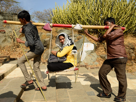 PALITANA, GUJARAT, INDIA - JANUARY 25: Indian pilgrims carried on primitive sedan chairs to the holy Palitana top in the Gujarat state in India, Palitana in January 25, 2015のeditorial素材