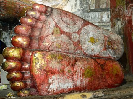 Feet of reclining buddha in ancient Buddhist complex in Dambulla cave temple. Sri Lanka. The photograph is presenting the statue of Buddhaのeditorial素材