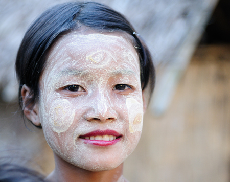 BAGAN, MYANMAR - JANUARY 25: Portrait of the Burmese woman in traditional make-up made of Murrays powdered wood in the Bagan town on January 25, 2011のeditorial素材