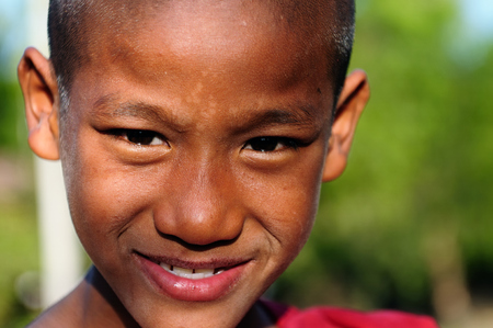 MRAUK-U, MYANMAR - JANUARY 25: Portrait of the young Burmese monk coming back from prayers from one of ancient temples in Mrauk-U town on January 25, 2011のeditorial素材