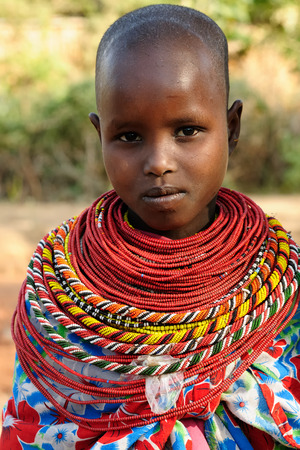 SOUTH HORR, KENYA - JULY 08: Young African girl from the Samburu tribe with characteristic decorative necklaces on the market in Kenya, South Horr in July 08, 2013のeditorial素材