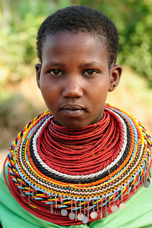 SOUTH HORR, KENYA - JULY 08: Young African girl from the Samburu tribe with characteristic decorative necklaces on the market in Kenya, South Horr in July 08, 2013のeditorial素材