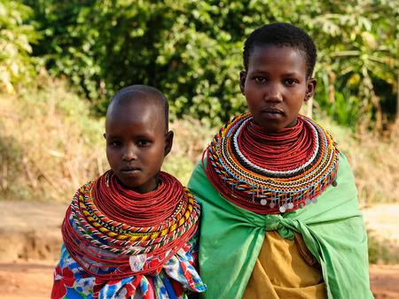 SOUTH HORR, KENYA - JULY 08: Young African girls from the Samburu tribe with characteristic decorative necklaces on the market in Kenya, South Horr in July 08, 2013のeditorial素材