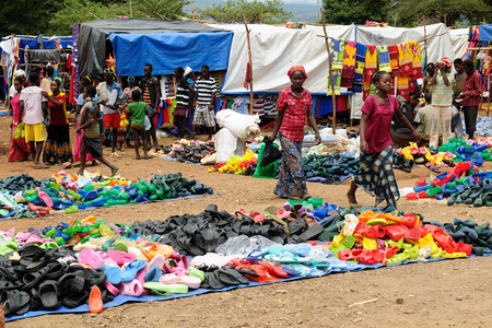 JINKA, ETHIOPIA - 25 JULY 2013: Local Ethiopian people being a market trader in the Jinka town in the Omo valley in Ethiopiaのeditorial素材