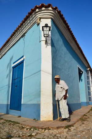 TRINIDAD, CUBA - 07 NOVEMBER 2016: City dweller going about the walking stick along stone city streetsのeditorial素材
