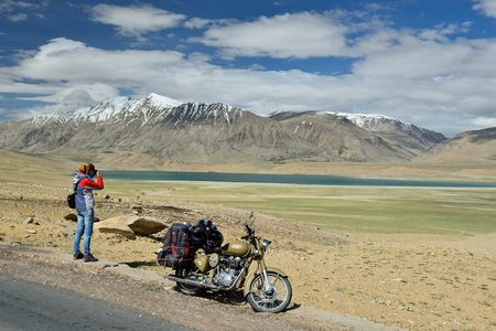 TSO KAYGAR, JAMMU AND KASHMIR, INDIA - 05 JULY 2017: Traveller photographing the Tso Kyagar Lake in the Karakorum Mountains near Leh, India. This region is a purpose of motorcycle expeditions organised by Indiansのeditorial素材