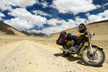 TSO KARI, JAMMU AND KASHMIR, INDIA - 06 JULY 2017: Motorbike Royal Enfield standing by the Karakorum Mountains near Leh, India. This region is a purpose of motorcycle expeditions organised by Indiansのeditorial素材