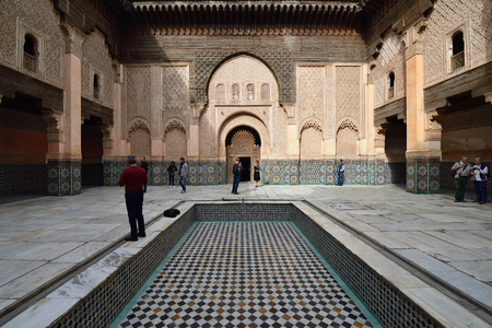 MARRAKESH, MOROCCO - 07 DECEMBER 2015: Tourists touring the interior courtyard of the 14th century Ben Youssef Madrasa or college in Marrakechのeditorial素材