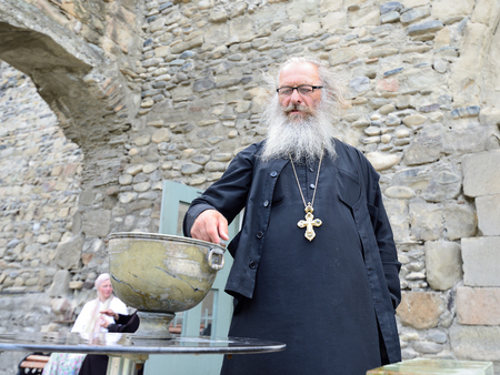 MCCHETA, GEORGIA - 05 JULE 2018: The priest of an Georgian Orthodox church is blessing faithful...