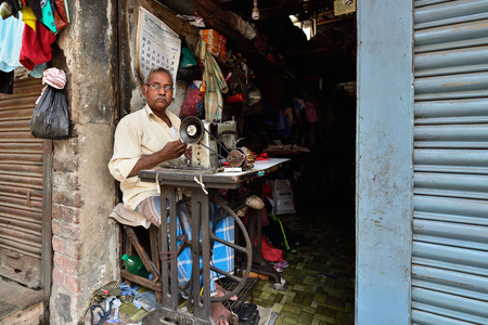CALCUTTA, WEST BENGAL INDIA - 21 DECEMBER 2018: The tailor's shop on crowded streets of Calcutta in the West Bengalのeditorial素材