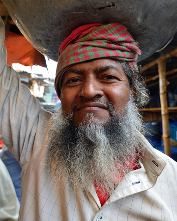 DHAKA, BENGAL BANGLADESH - 26 JANUARY 2019: Portrait of the carrier at the market fish in Dhakaのeditorial素材