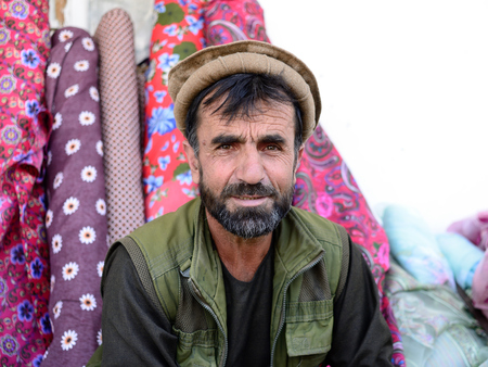 KHOROG, PAMIR MOUNTAINS, TAJIKISTAN - 06 JULY 2019: Portrait of the people of Afghanistan which is trading on the market in Tajikistan in the Pamir Mountainsのeditorial素材