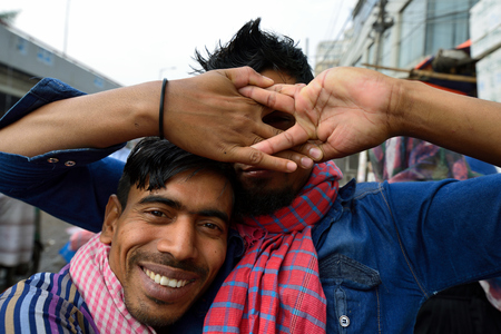 DHAKA, BENGAL BANGLADESH - 26 JANUARY 2019: Two young friends hugging in the street in Bangladeshのeditorial素材