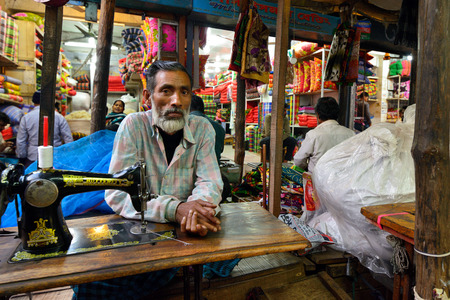 Khulna, Bangladesh - 30 JANUARY 2019: Tailor sitting behind sewing machines on the market in the Khulna townのeditorial素材