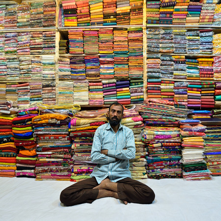 Khulna, Bangladesh - 30 JANUARY 2019: Seller of multicoloured materials on one's stall on the market in the Khulna townのeditorial素材