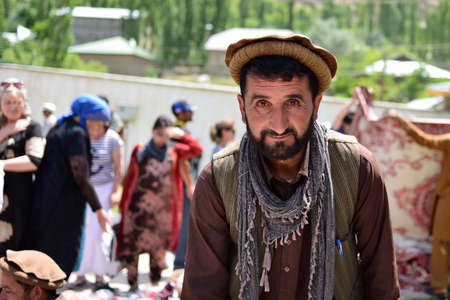 KHOROG, PAMIR MOUNTAINS, TAJIKISTAN - 06 JULY 2019: Portrait of the people of Afghanistan which is trading on the market in Tajikistan in the Pamir Mountainsのeditorial素材