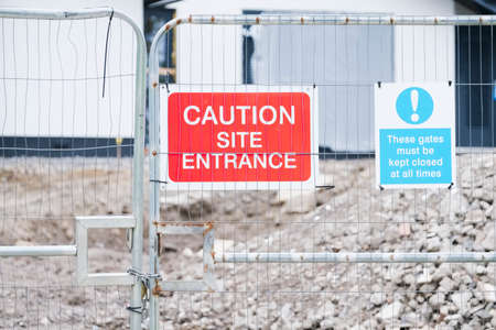 Construction building site sign at entrance on gateの写真素材