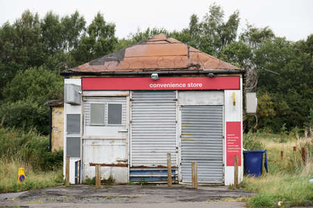 Derelict abandoned shop business in poor housing crisis ghetto estate slum Paisley