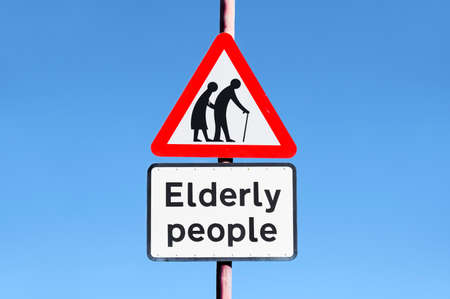 Elderly senior people sign against plain backgroundの写真素材
