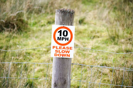 Speed limit sign in rural countryside on post