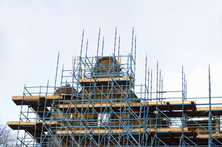 Scaffolding surrounding house renovation for safe access to refurbishment height