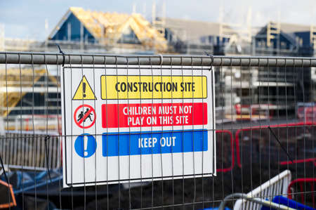 Construction site health and safety message rules sign board signage on fence boundaryの写真素材