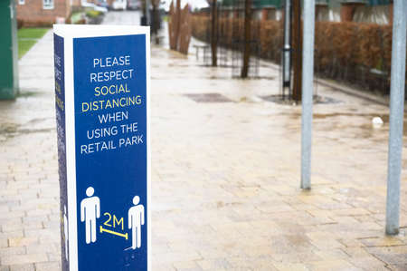 Social distancing sign shop customers to respect and stay safeの写真素材