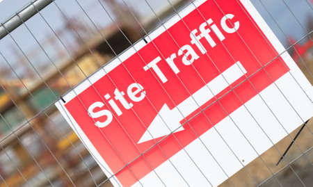 Site traffic direction sign at construction site entrance