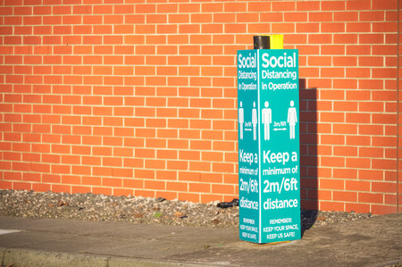 Social distancing sign shop customers to respect and stay safeの写真素材