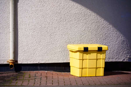 Large yellow bin for rubbish with secure lockの写真素材