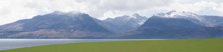 Arran viewed from Rothesay in Isle of Bute under dark cloudsの写真素材