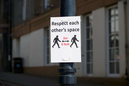 Social distancing sign shop customers to respect and stay safe