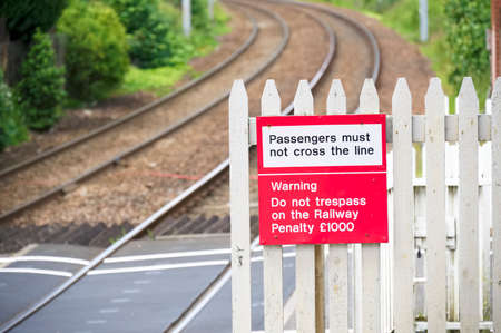 Stop look listen safety road sign at railway train station danger warning sign