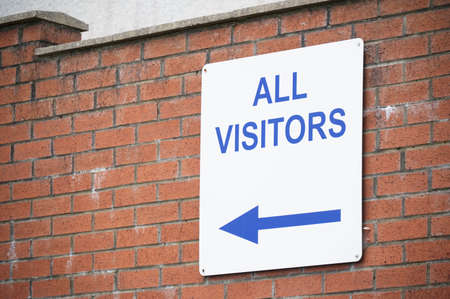 All visitors arrow direction sign on wall of car parkの写真素材