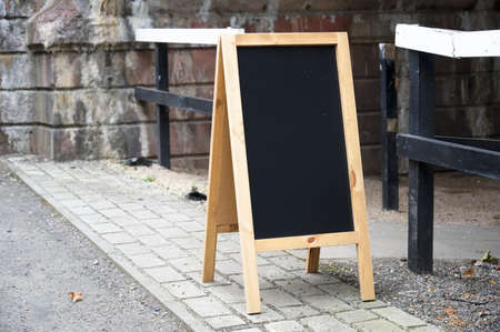 Blackboard blank wooden sign outside of cafe