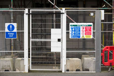 Access gate to construction site and health and safety message rules sign board signage