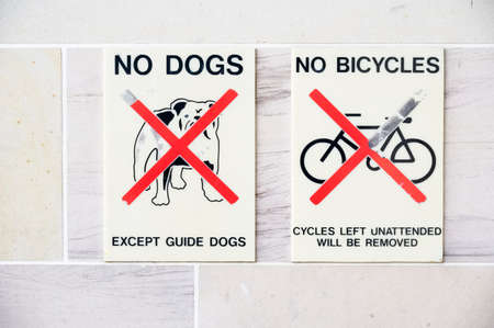 No dogs or bicycles allowed sign at entrance to buildingの写真素材