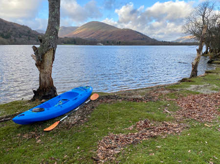 Blue kayak moored on island at Loch Lomondの写真素材