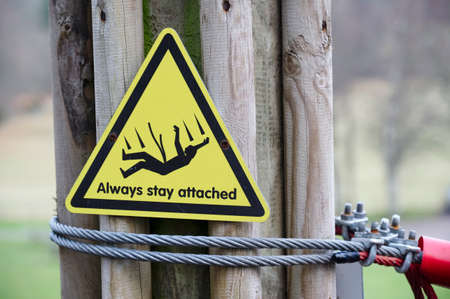 Adventure playground danger and risk sign on fence