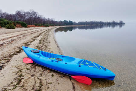 Blue kayak on open water in fog and mist at Loch Lomondの写真素材
